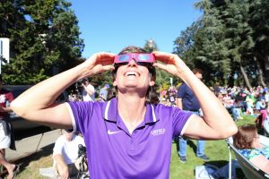 Woman staring at eclipse with special glasses