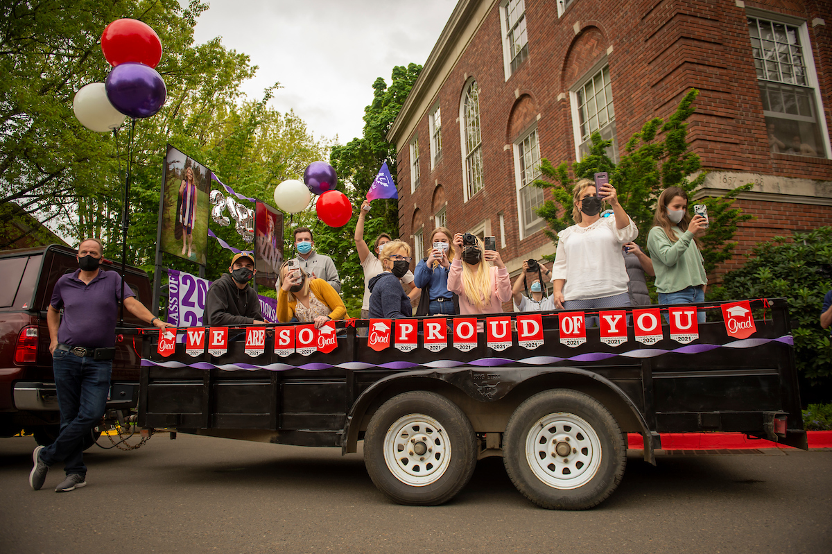 A trailer full of family celebrate graduates