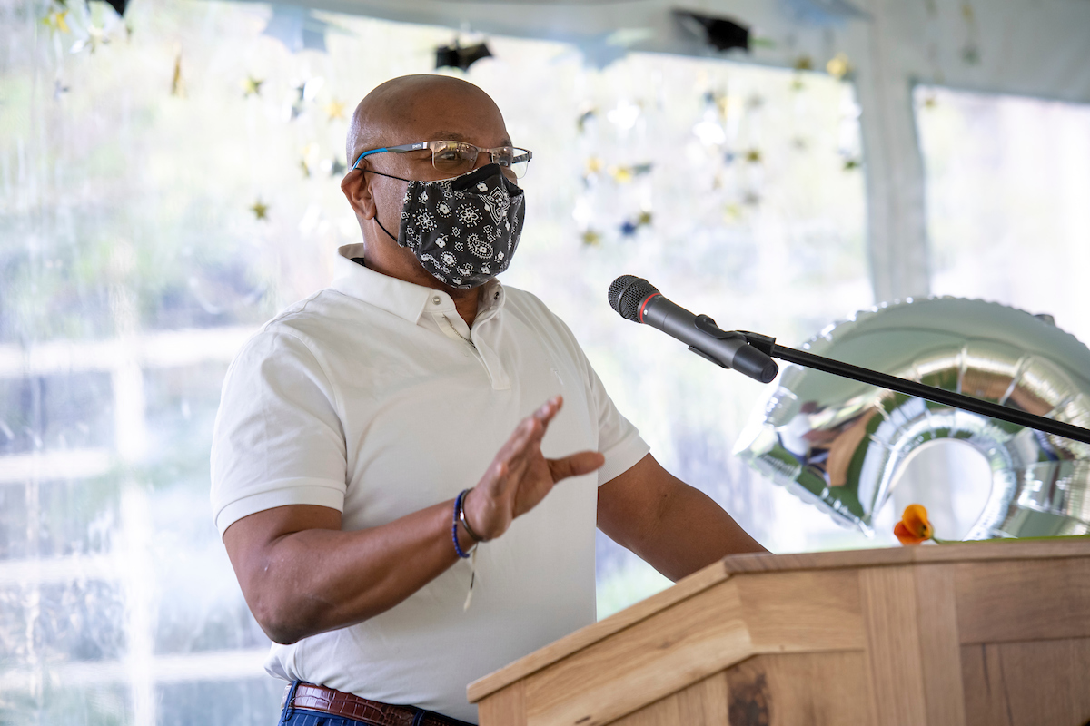 President Davis addresses the crowd from a podium