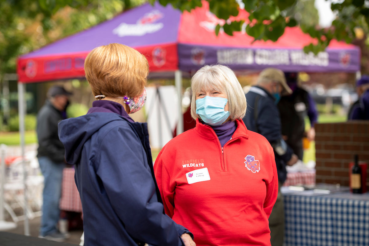 Alumni wear masks at outdoor homecoming event