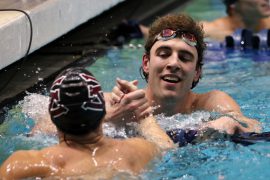 Garrett Sutton congratulates a fellow competitior at the Northwest Conference Swimming Championships. The men's and women's swimming teams wrapped up their 2021-22 season with conference championships in three relays and three individual events. 