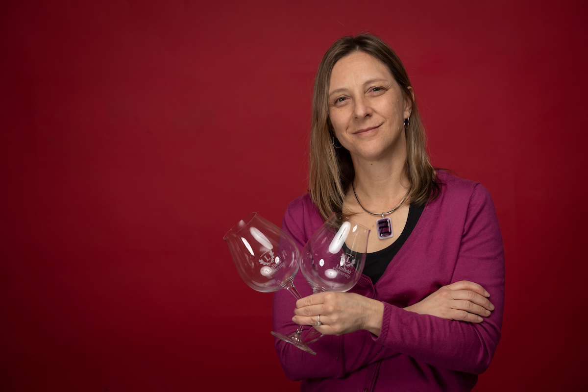 Toni Ketrenos hold a set of wine glasses
