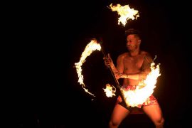 A Linfield University student performs a fire dance at the 2021 Lūʻau & Hōʻike.