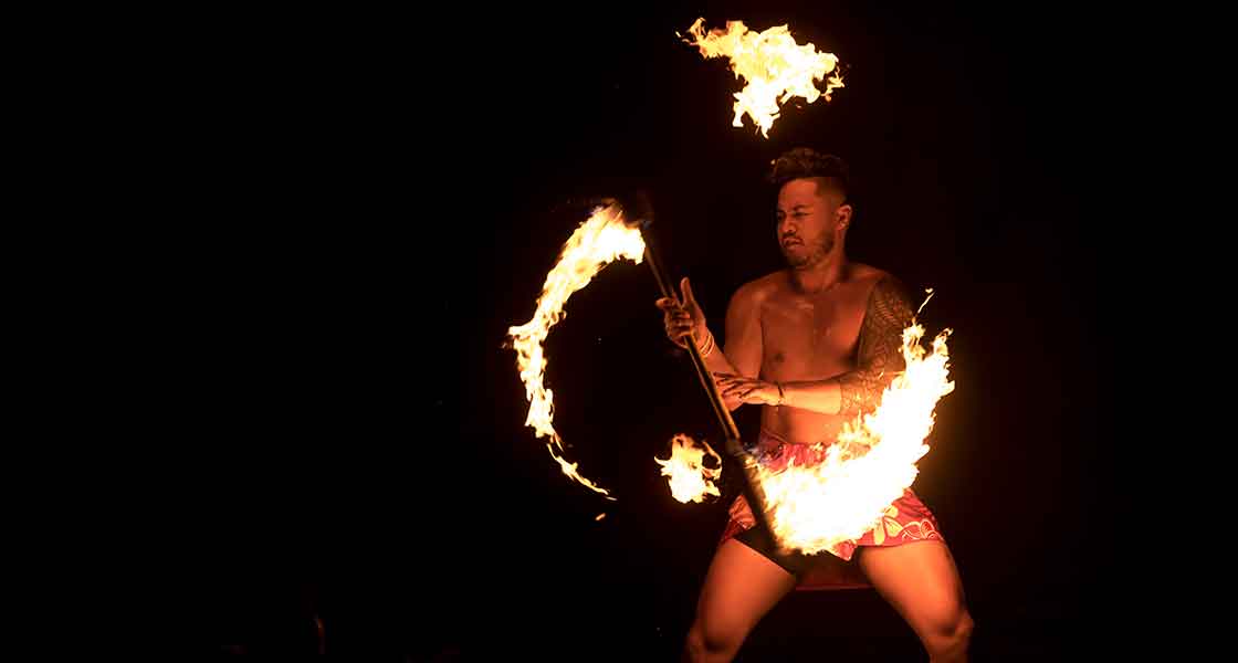 A Linfield University student performs a fire dance at the 2021 Lūʻau & Hōʻike.