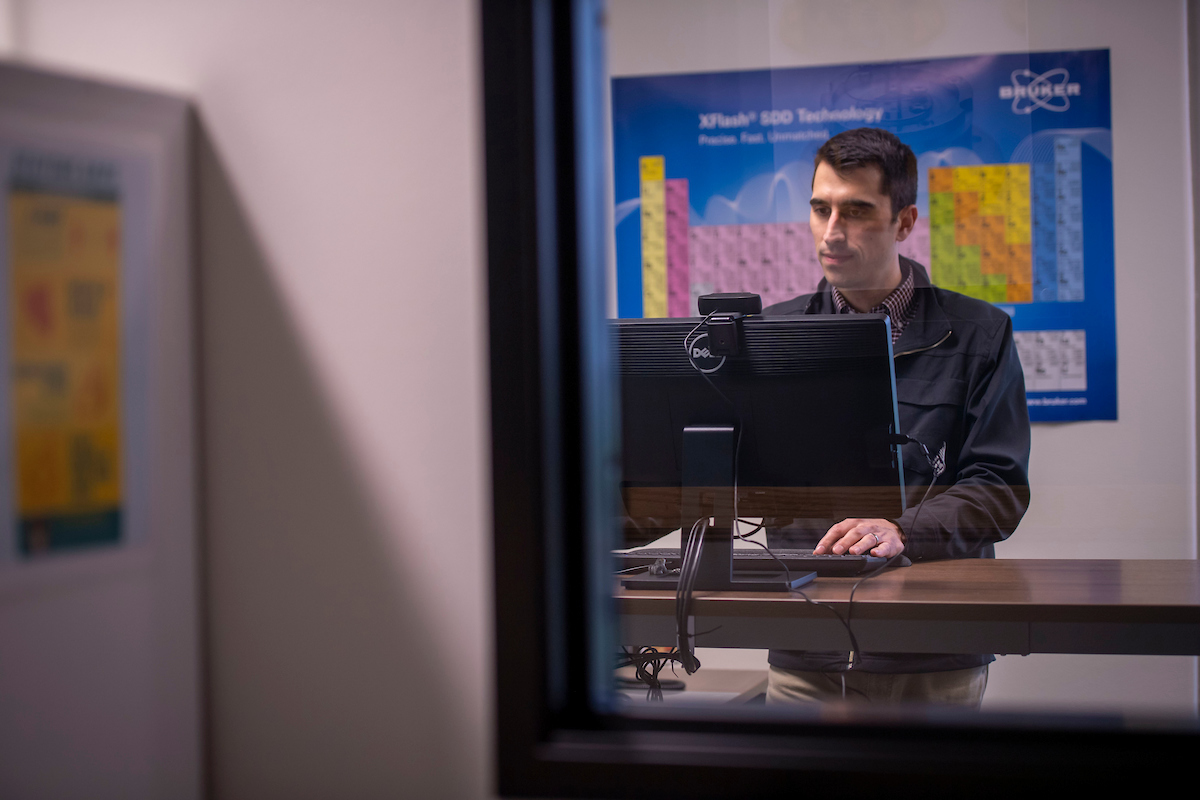 Alumnus Josh Lovell types at his standing desk