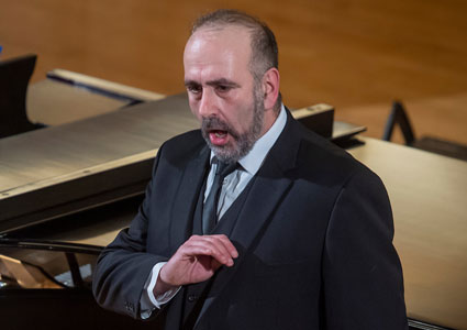 Linfield Professor Anton Belov performing opera in Ice Auditorium during a benefit for Ukraine