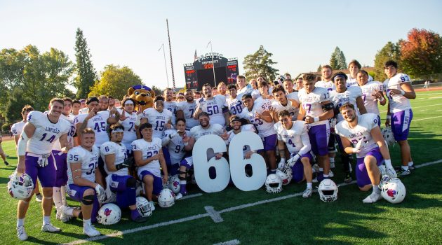 Wildcat football team poses with large numbers 66 for The Streak