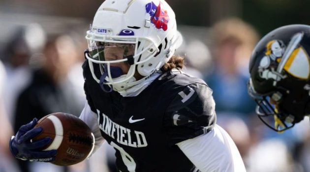 Linfield football player runs the ball