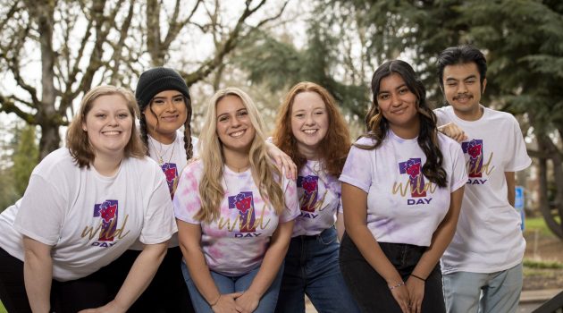 A group of Linfield students wear 'One Wild Day' t-shirts.