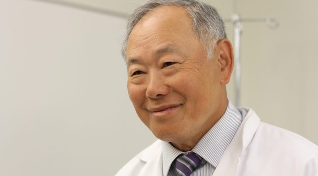 Dr. Harold Tu in his lab coat.