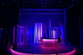 The set of Hurricane Diane, lit in blue and pink light.