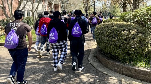 Mente Summit attendees walk by Riley Campus Center.