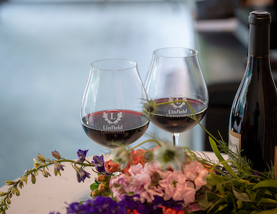 Linfield-branded wine glasses filled with pinot noir.