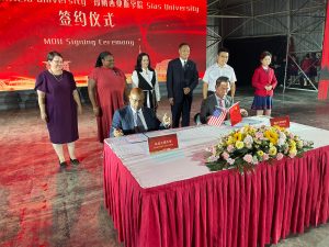 Linfield President Miles K Davis and Chairman Shawn Chen sign a memorandum of understanding.