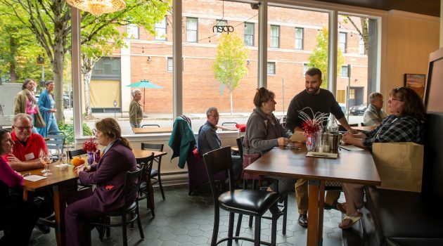 Patrons sit in a spacious wine tasting room