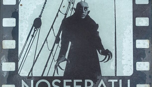 A monstrous-looking man with long claws and a deranged expression stands in front of ship rigging.