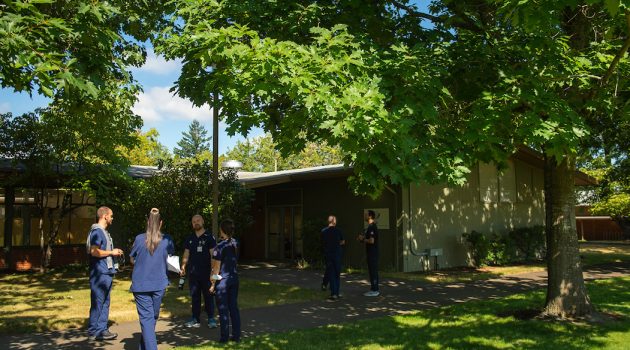 nursing students standing outside a building on the Portland campus.
