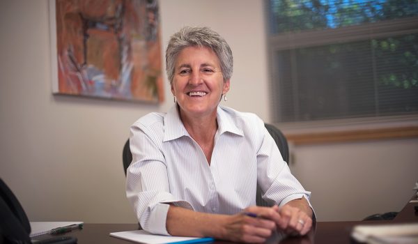 Becky Johnson sits at a desk