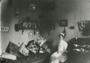 A portrait of Emily Loveridge seated in a private room.