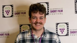 Linfield University student Andrew Goodwin poses for a picture at the 2023 McMinnville Short Film Festival