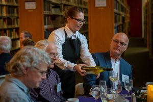 A server pours wine