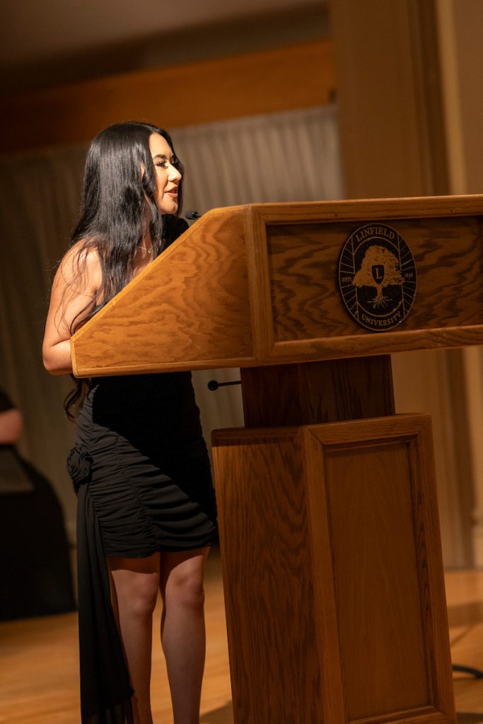 A student speaker stands at a podium during Linfield University’s Baccalaureate.