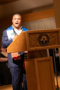 A student speaker stands at a podium during Linfield University’s Baccalaureate.