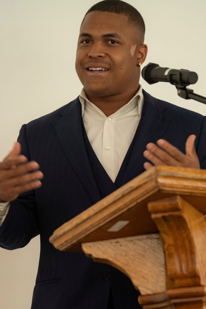 A student speaker stands at the podium during the Black Excellence Ceremony at Linfield University.