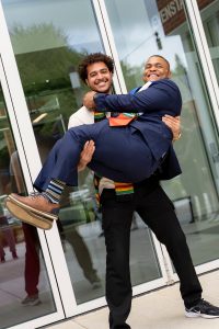 Students wearing a kente-striped stoles pose during the Black Excellence Ceremony at Linfield University.
