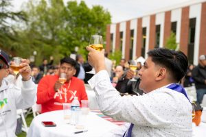 Attendees raise their glasses in a toast during the Linfield University Latine Dinner.