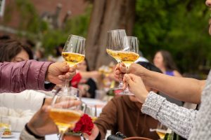 Attendees raise their glasses in a toast during the Linfield University Latine Dinner.