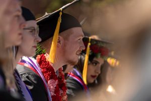 Students line up in their caps and gowns during the 2024 Linfield University Commencement.