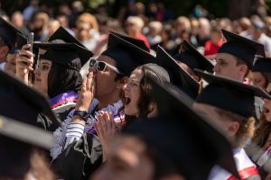 Students dressed in graduation caps and gowns celebrate during the 2024 Linfield University Commencement.