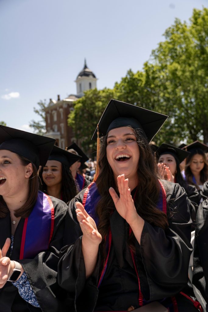 Students dressed in graduation caps and gowns celebrate during the 2024 Linfield University Commencement.