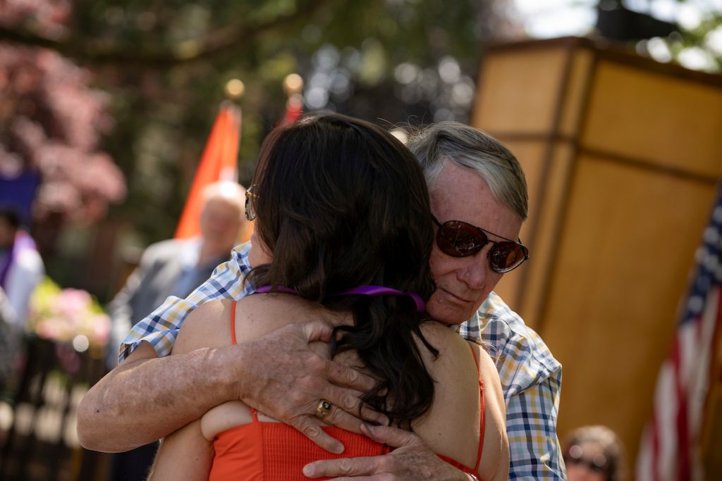 A family embraces during the Linfield University School of Nursing pinning ceremony.