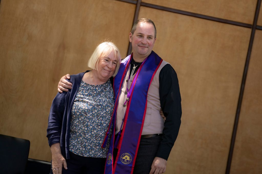 A family embraces during the Linfield University School of Nursing pinning ceremony.