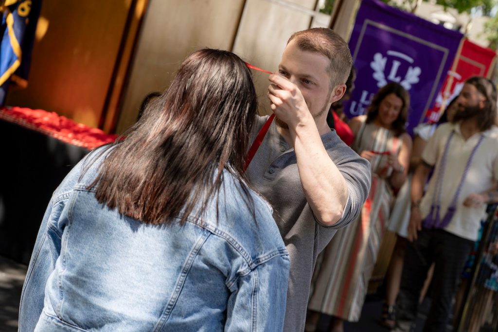 A family embraces during the Linfield University School of Nursing pinning ceremony.