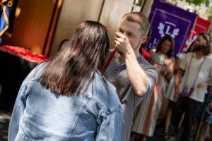 A family embraces during the Linfield University School of Nursing pinning ceremony.