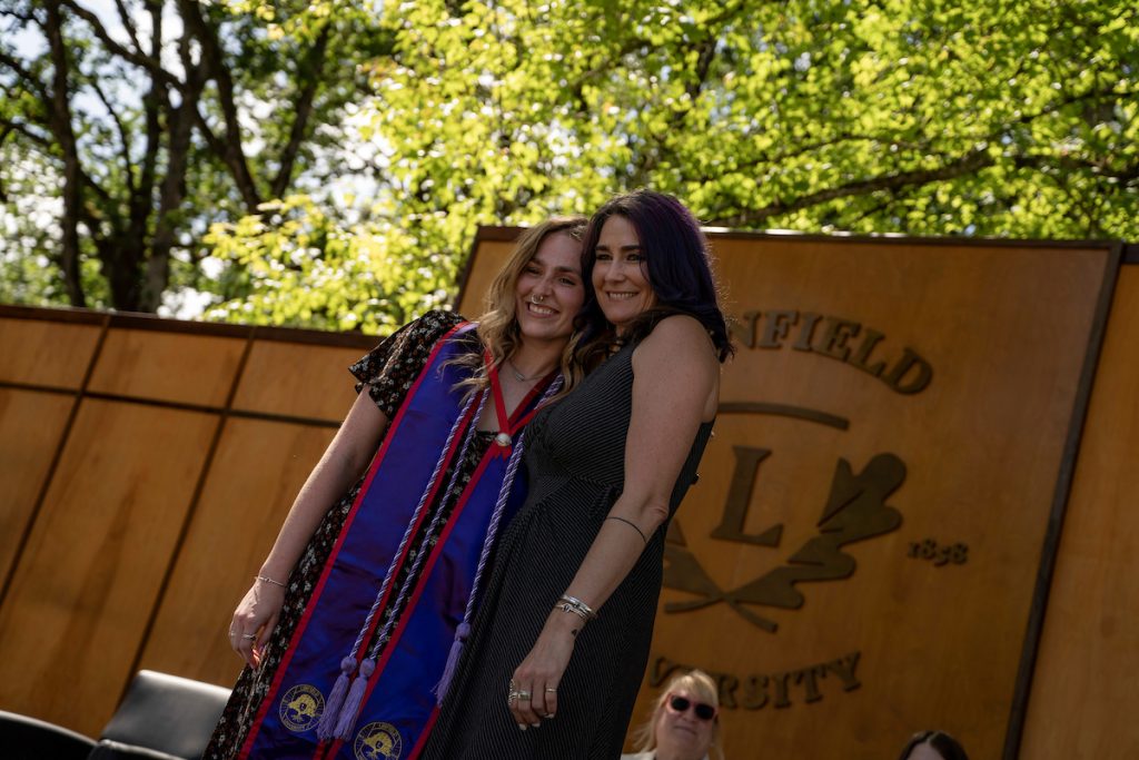 A family embraces during the Linfield University School of Nursing pinning ceremony.