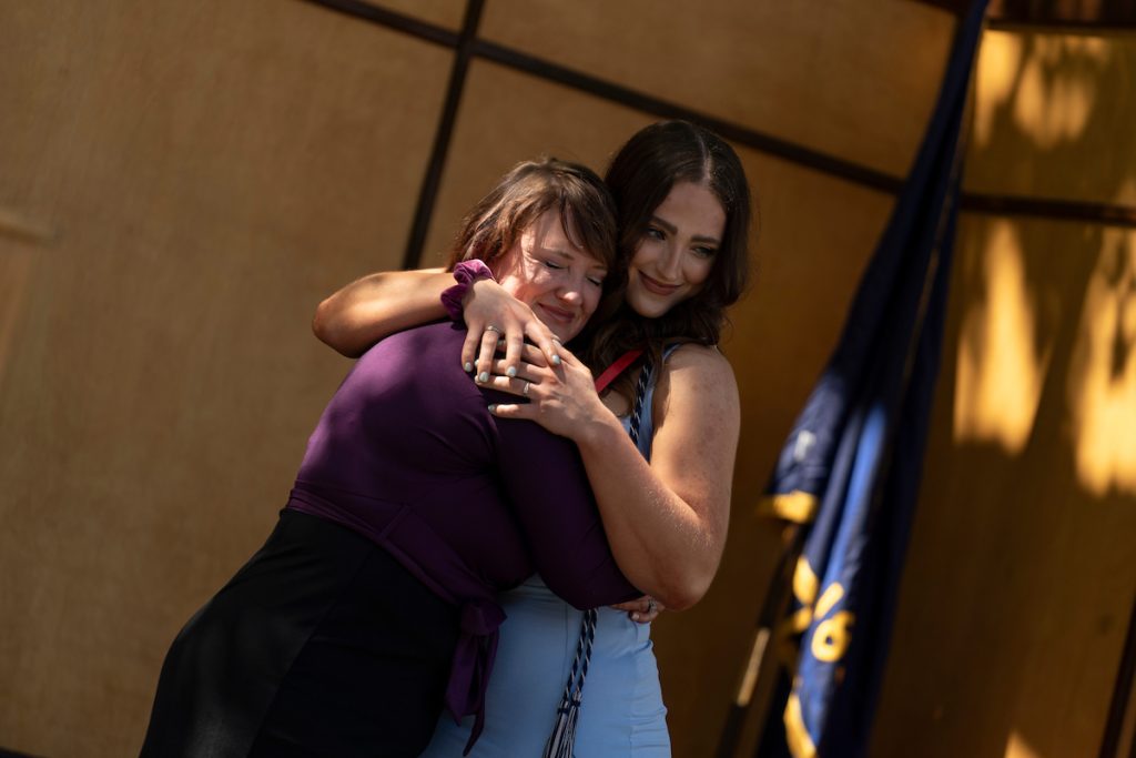 A family embraces during the Linfield University School of Nursing pinning ceremony.