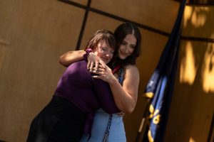 A family embraces during the Linfield University School of Nursing pinning ceremony.