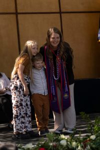 A family embraces during the Linfield University School of Nursing pinning ceremony.