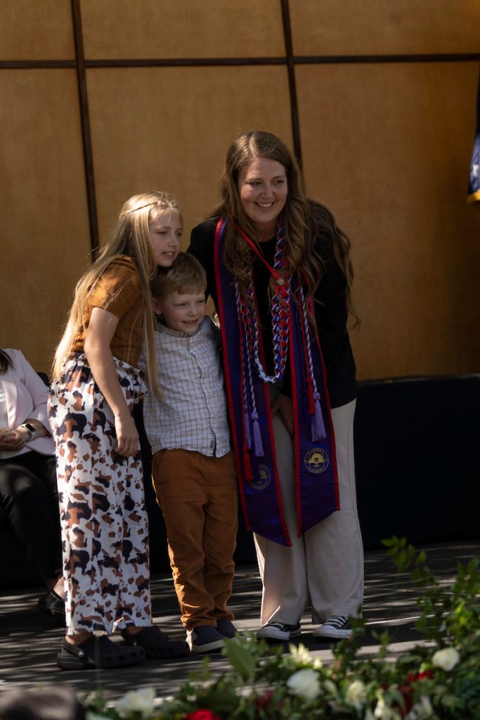 A family embraces during the Linfield University School of Nursing pinning ceremony.