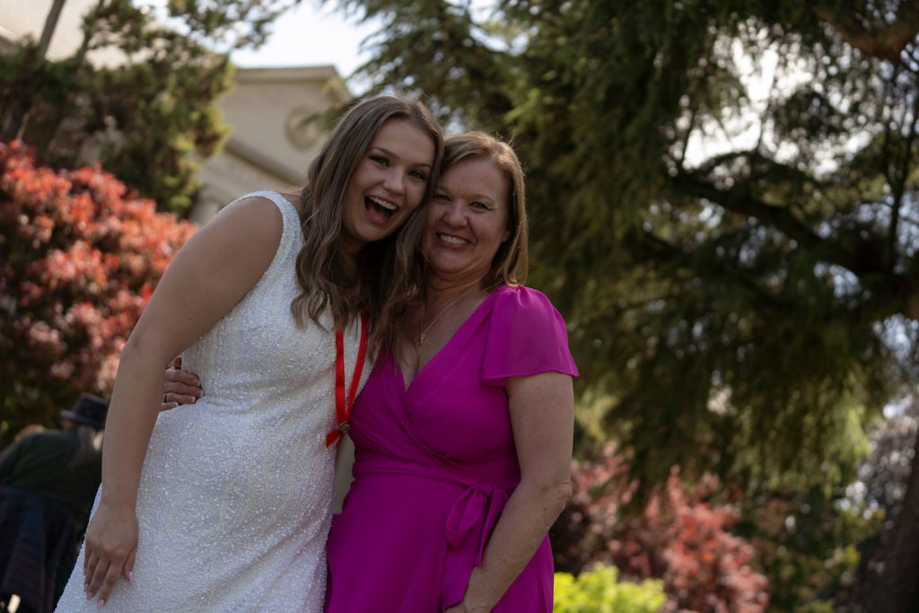 A family poses and smiles at the Linfield University School of Nursing 2024 Pinning Ceremony.