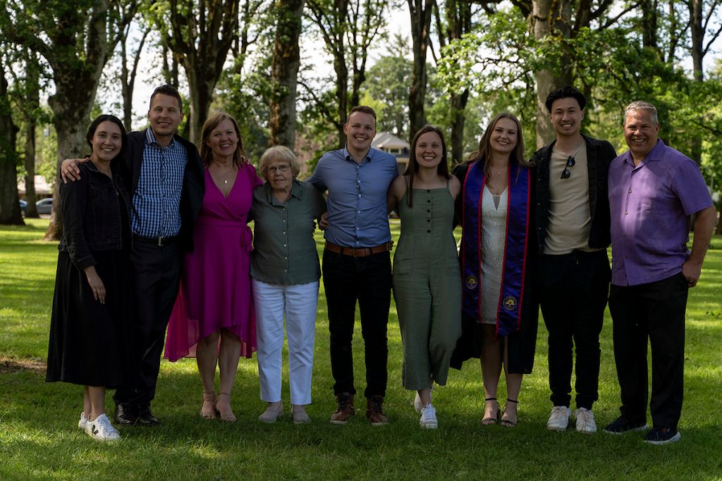 A family poses and smiles at the Linfield University School of Nursing 2024 Pinning Ceremony.