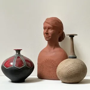 Three ceramics including two thin-neck vases and a bust. 