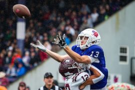 Football player catches a ball 