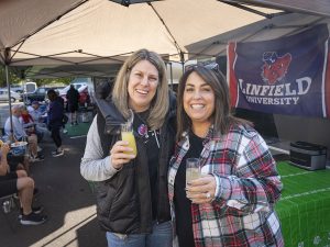 Two people smile for a photo during Linfield Homecoming 2024