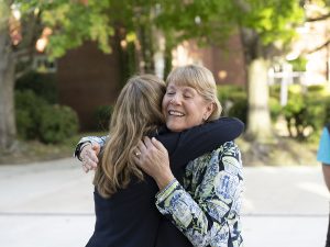 Two people hugging during Linfield Homecoming 2024