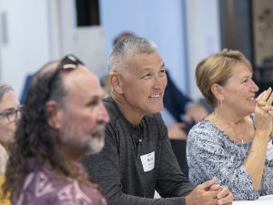 People smiling in a classroom during Linfield Homecoming 2024